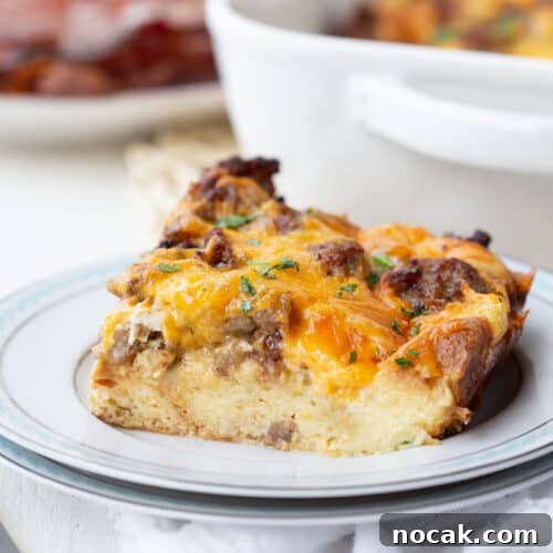slice of sausage and egg casserole on a white plate.