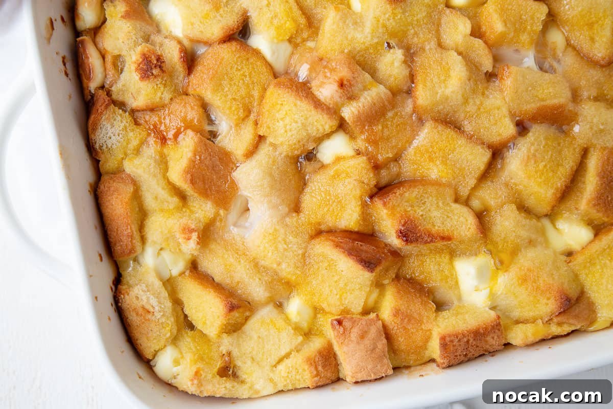 Baked Stuffed French Toast Casserole with Creamy Filling 7 baked stuffed french toast casserole in a white casserole dish with handles.