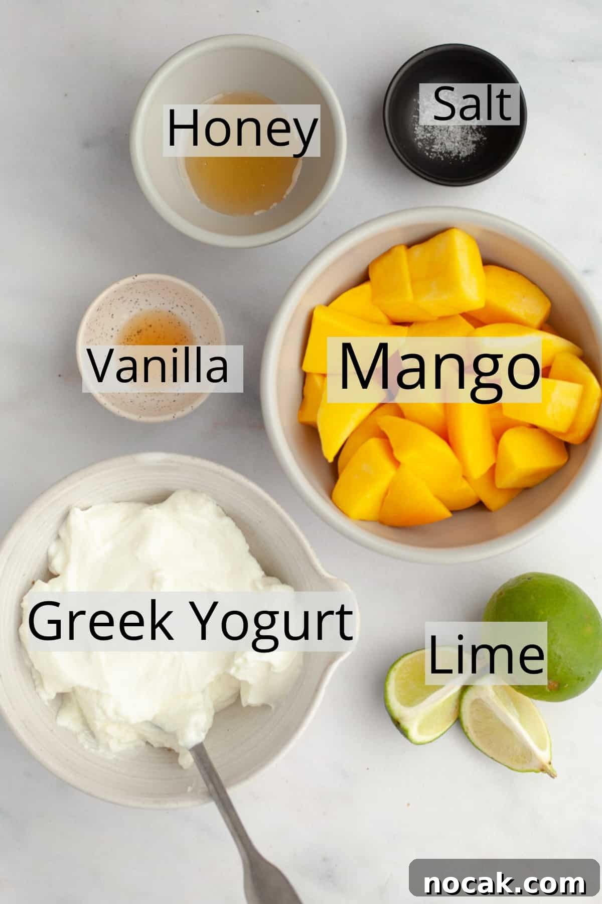 All the ingredients needed to make mango popsicles weighed out into small bowls.