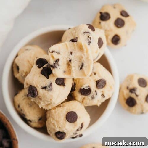 no bake chocolate chip cookie dough bites in a small ceramic bowl.