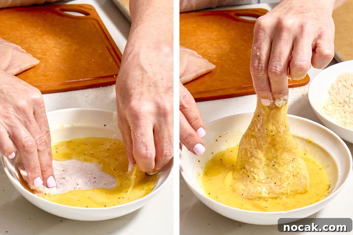 Crispy Breaded Chicken Cutlets: Step-by-Step Coating Guide 6 Woman dipping floured chicken into bowl of beaten eggs.