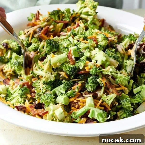 Crispy Breaded Chicken Cutlets: Step-by-Step Coating Guide 9 Two spoons in a bowl of Broccoli Salad.
