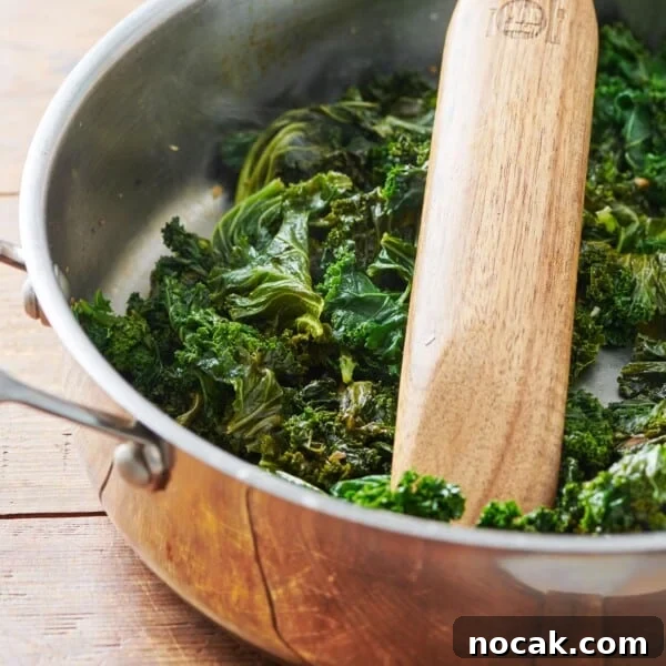 Crispy Breaded Chicken Cutlets: Step-by-Step Coating Guide 10 Cooked Kale in a pan with a wooden spatula.