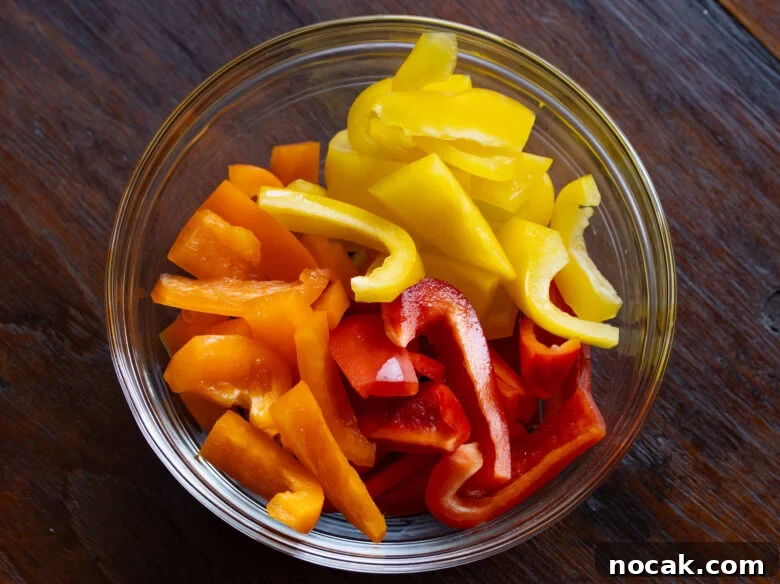 Cut into one inch chunks the bell peppers.