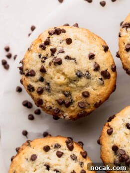 Top view of chocolate chip buttermilk muffins on a marble board.