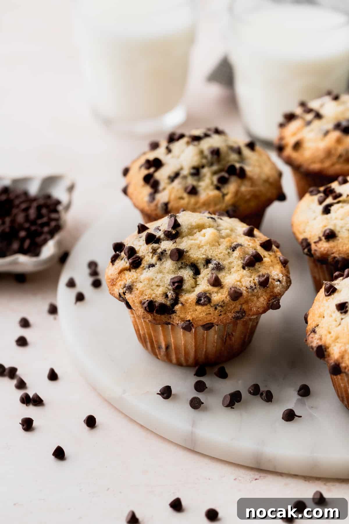 Chocolate chip buttermilk muffins on a marble board.