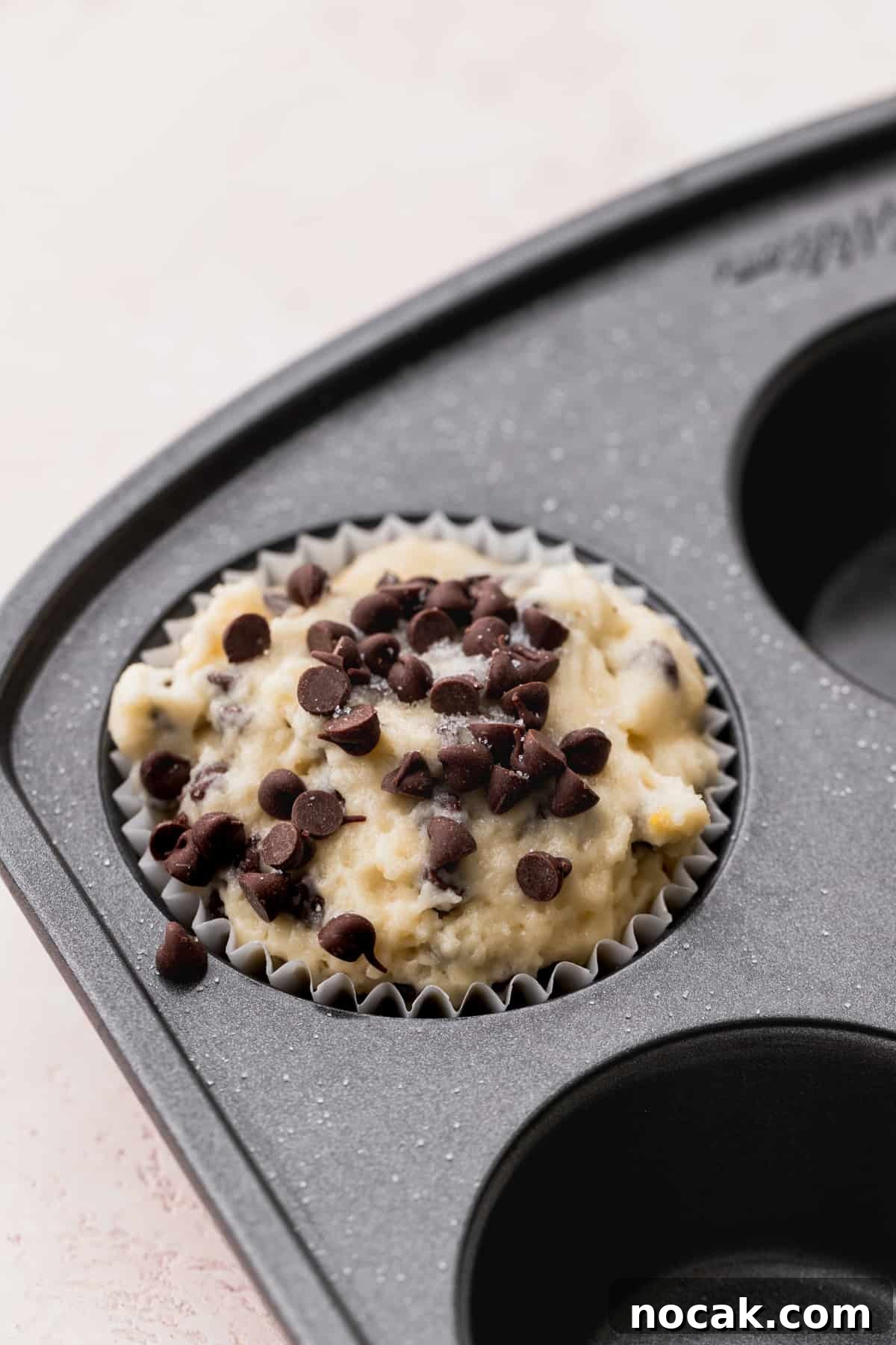 Close up of muffin batter in the tin.