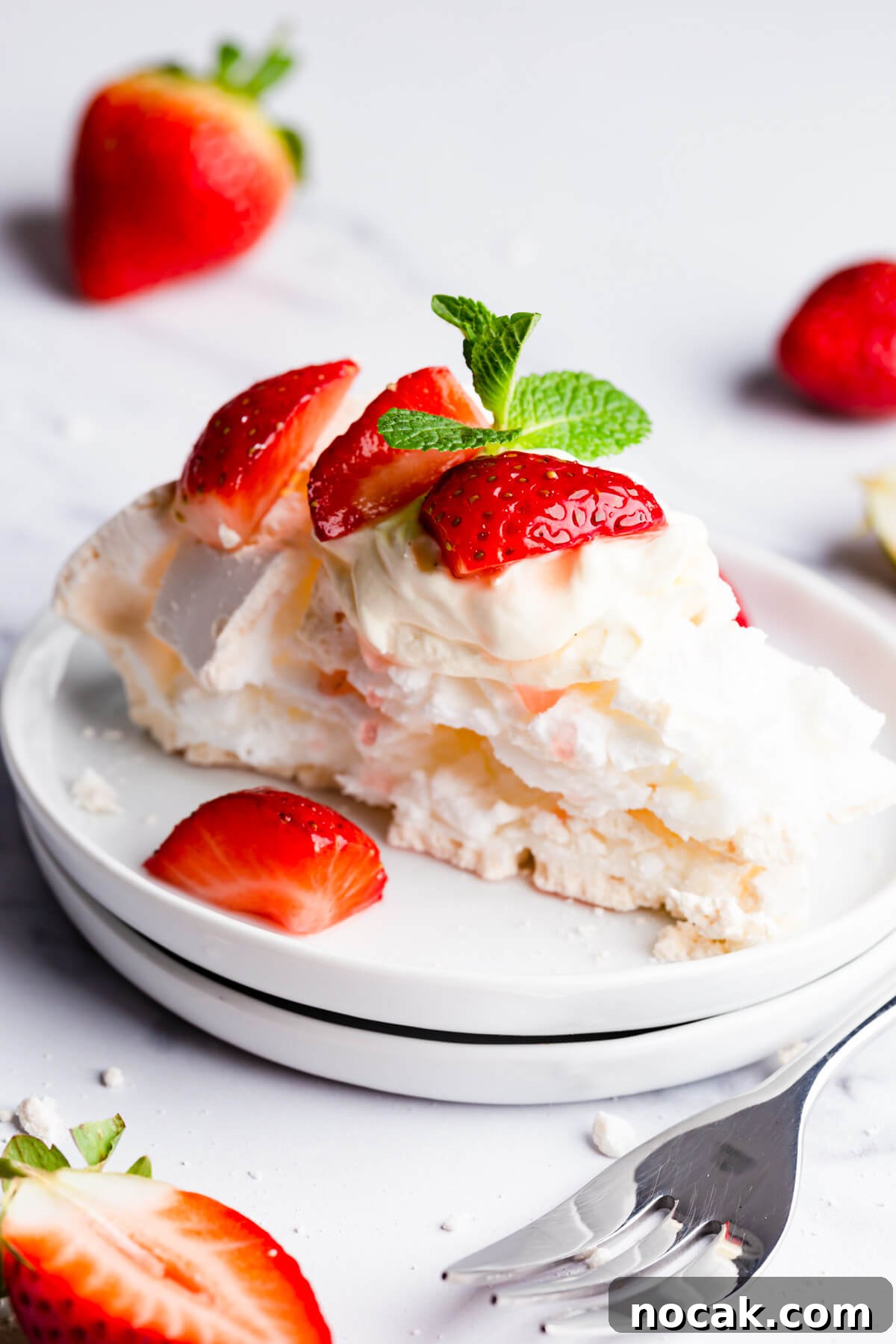 Strawberry Pavlova Recipe: Crisp Meringue with Fresh Berries 11 side close up at a slice of pavlova meringue on a small plate