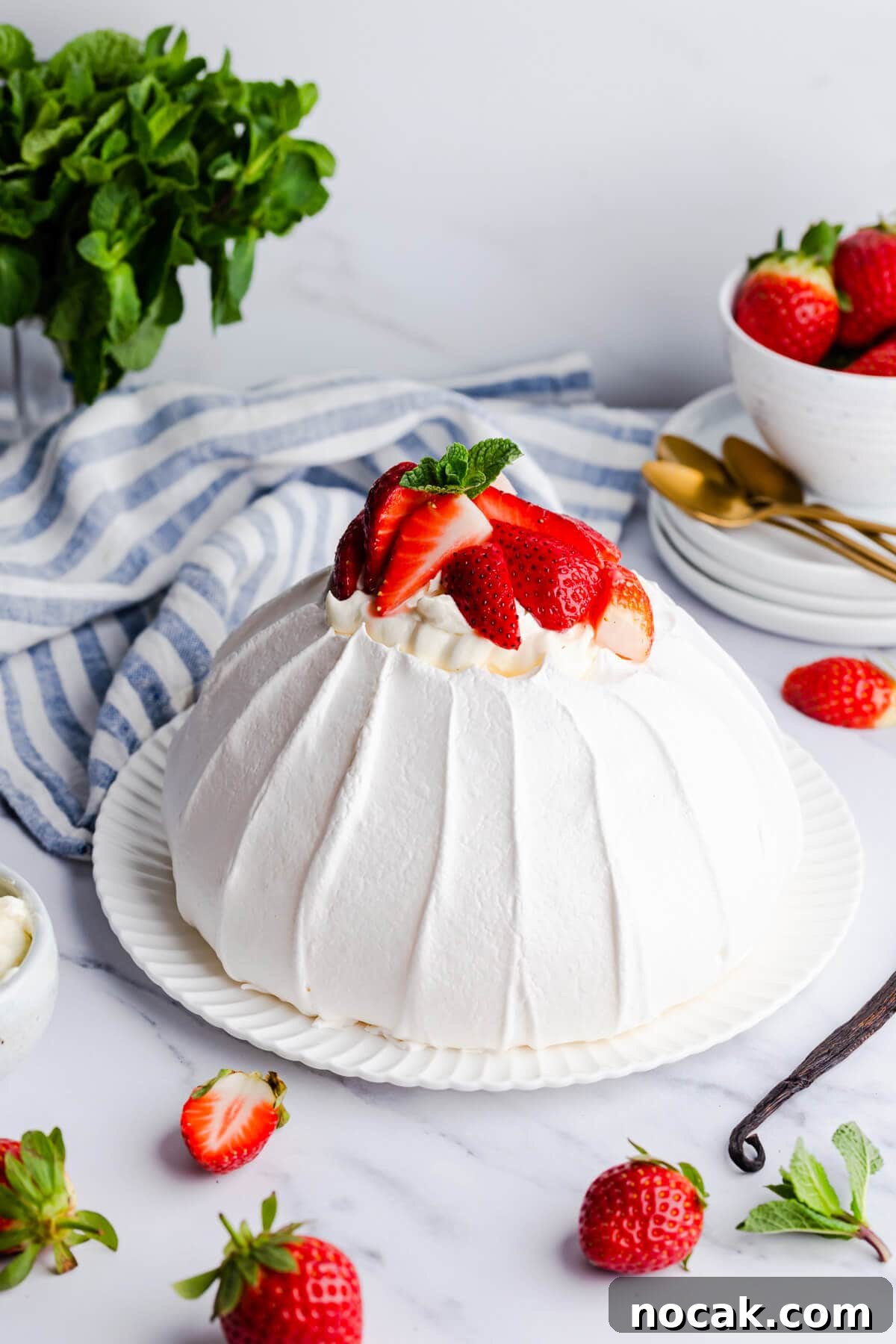 Strawberry Pavlova Recipe: Crisp Meringue with Fresh Berries 12 side view of the pavlova meringue on a white plate