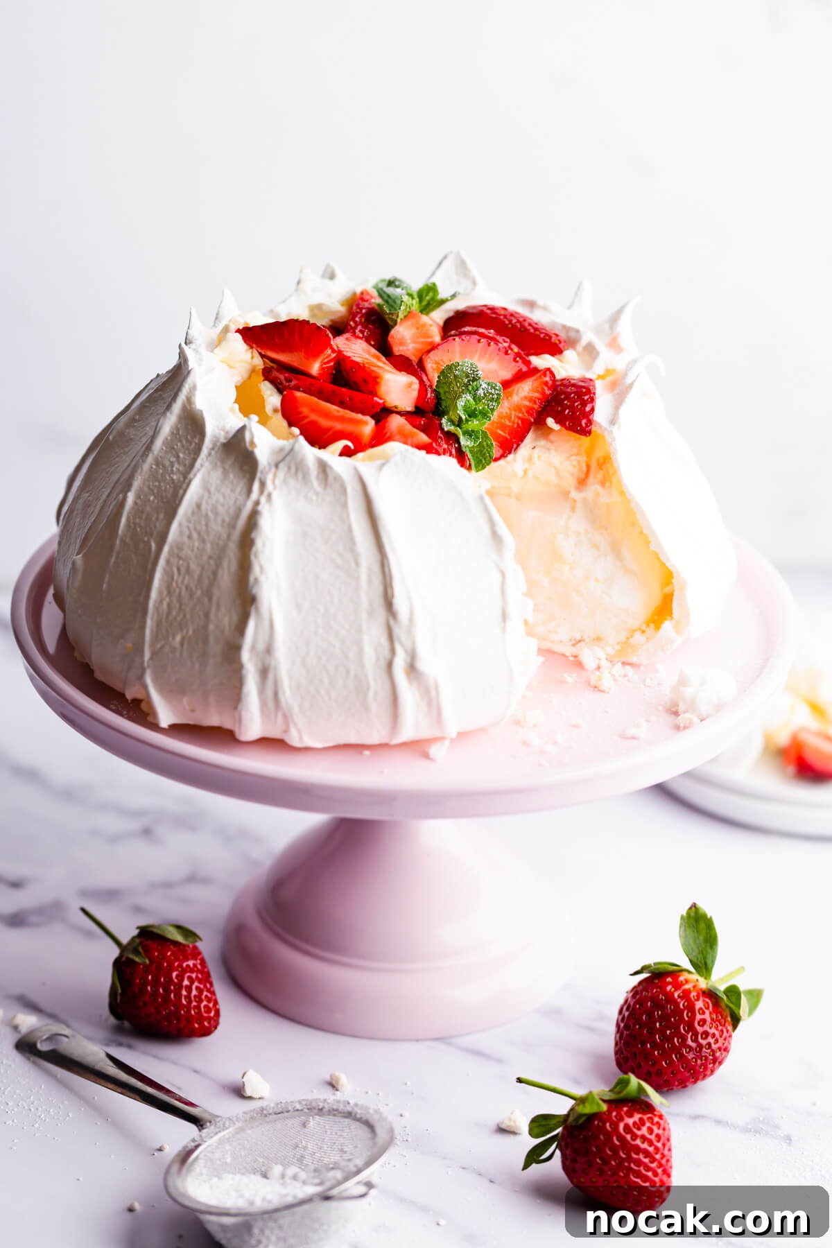 Strawberry Pavlova Recipe: Crisp Meringue with Fresh Berries 9 side view of the strawberry pavlova with a slice cut out of it