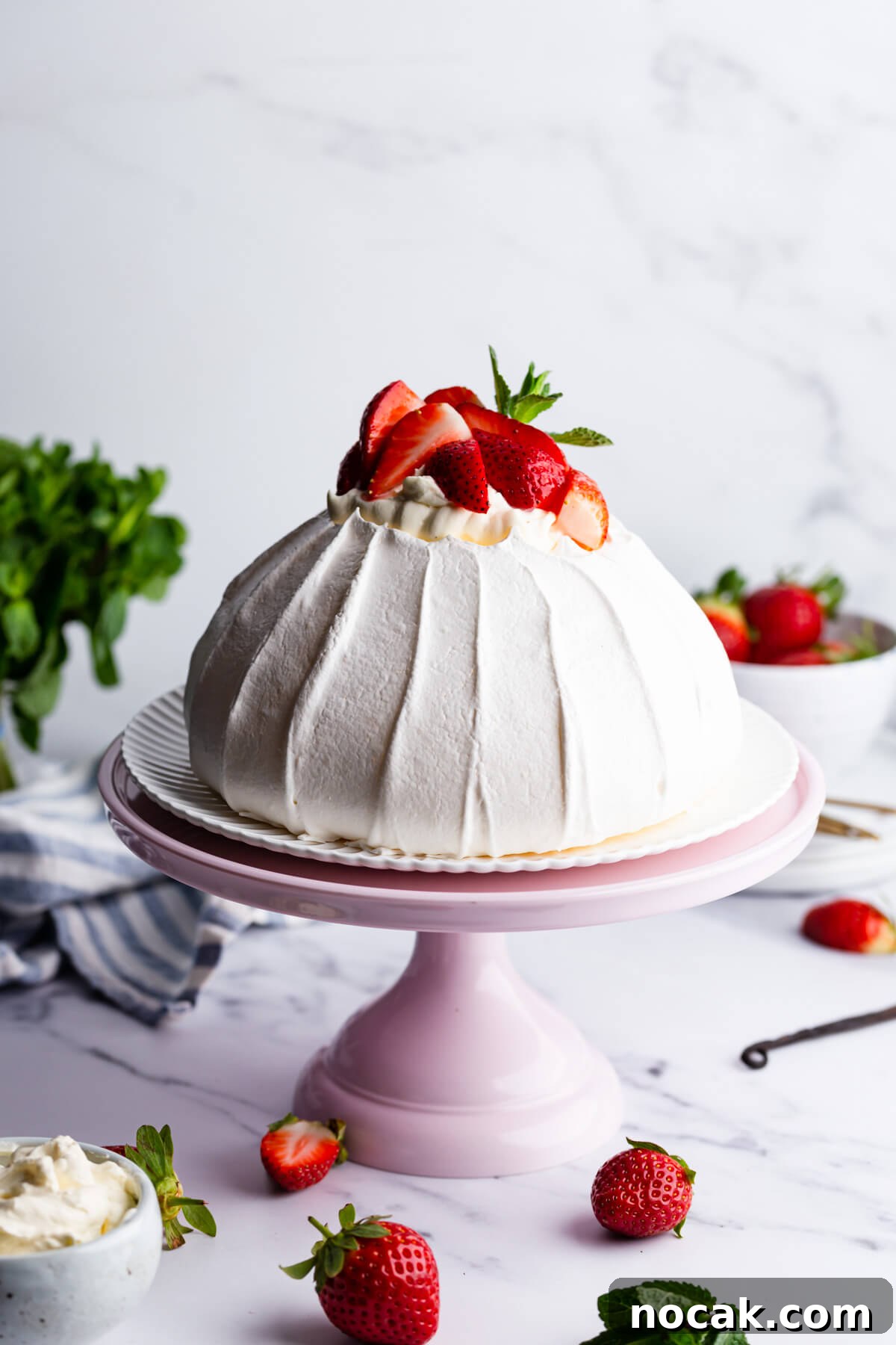 Strawberry Pavlova Recipe: Crisp Meringue with Fresh Berries 10 45 degree angle view of the strawberry pavlova on pink cake stand