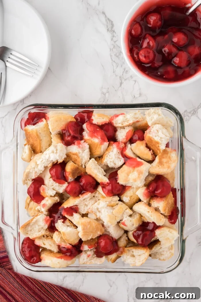 Cherry Bread Pudding Recipe with Fresh Cherry Sauce 5 Adding the filling on top of the biscuits.