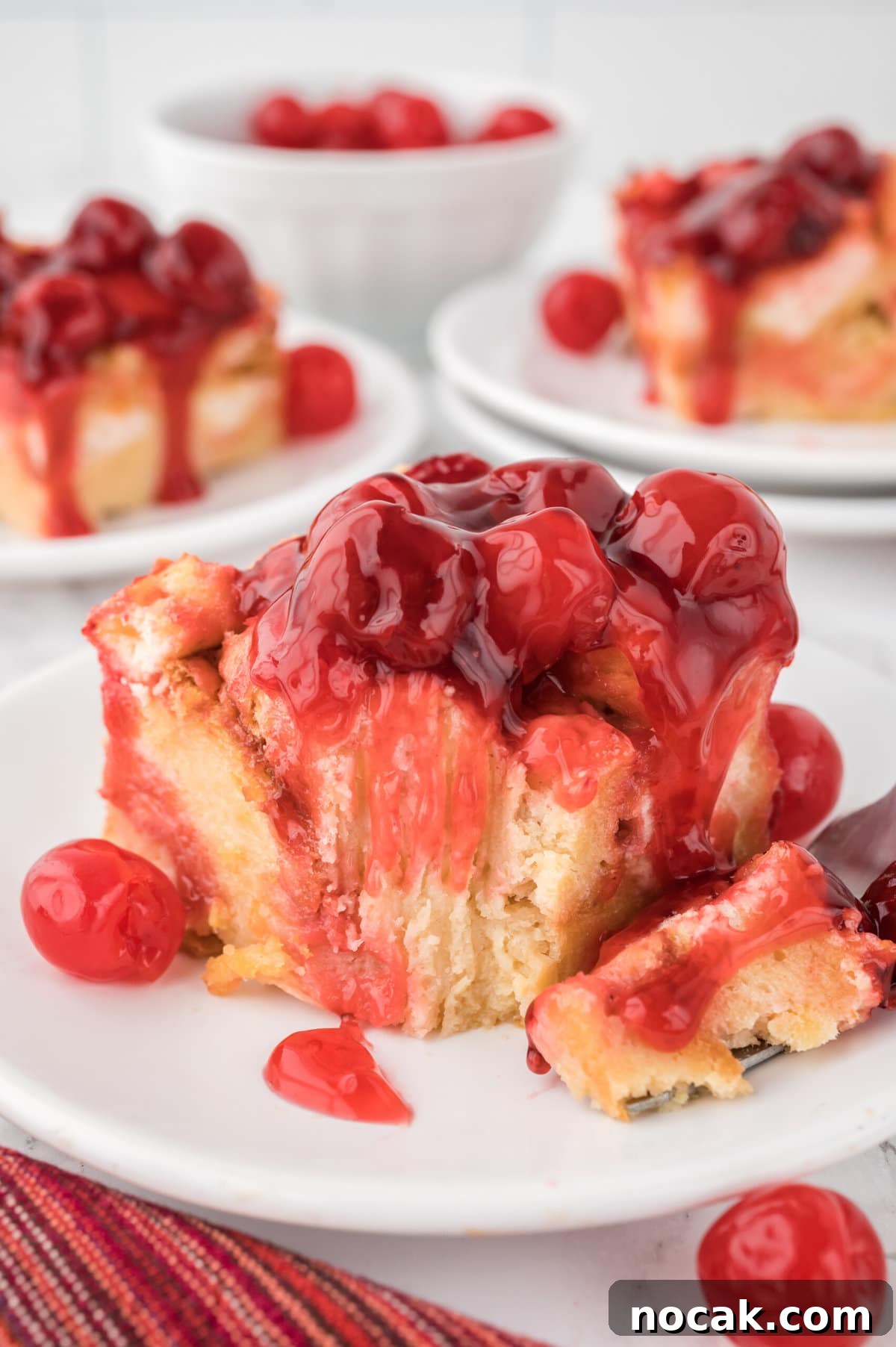 Cherry Bread Pudding Recipe with Fresh Cherry Sauce 9 Cherry Bread Pudding on a white plate.