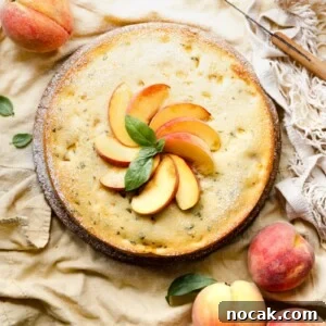 Basil Peach Ricotta Cake Recipe — Fresh Summer Dessert 5 Single layer cake topped with yellow peaches and basil on a wood board.
