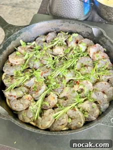 Smoked Garlic Herb Shrimp Recipe with Lemon Butter Glaze 2 seasoned shrimp in a cast iron
