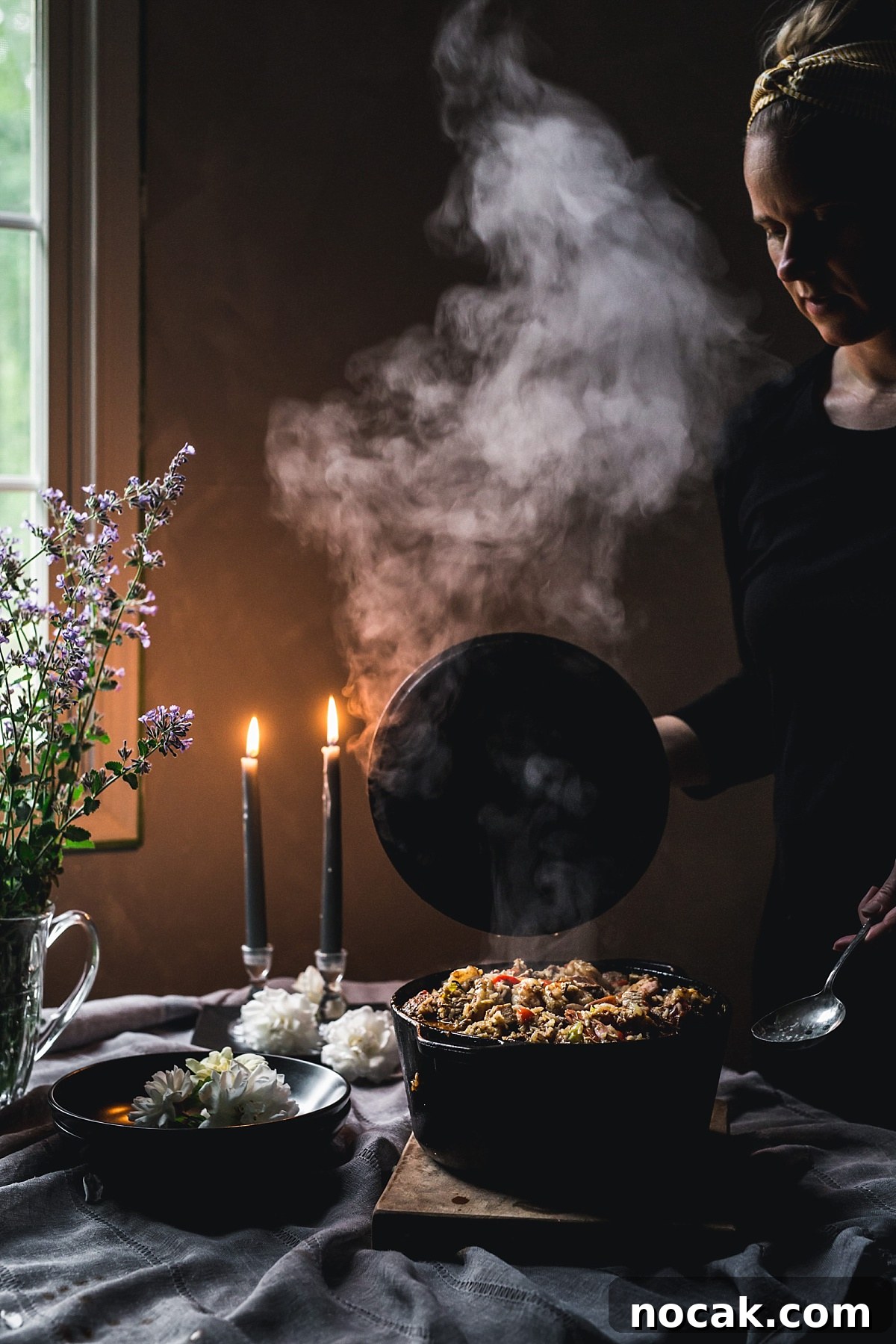 Paul Prudhomme’s Dutch Oven Jambalaya Recipe 2 moody shot of huge steam cloud escaping from overflowing dutch oven of Jumabalaya