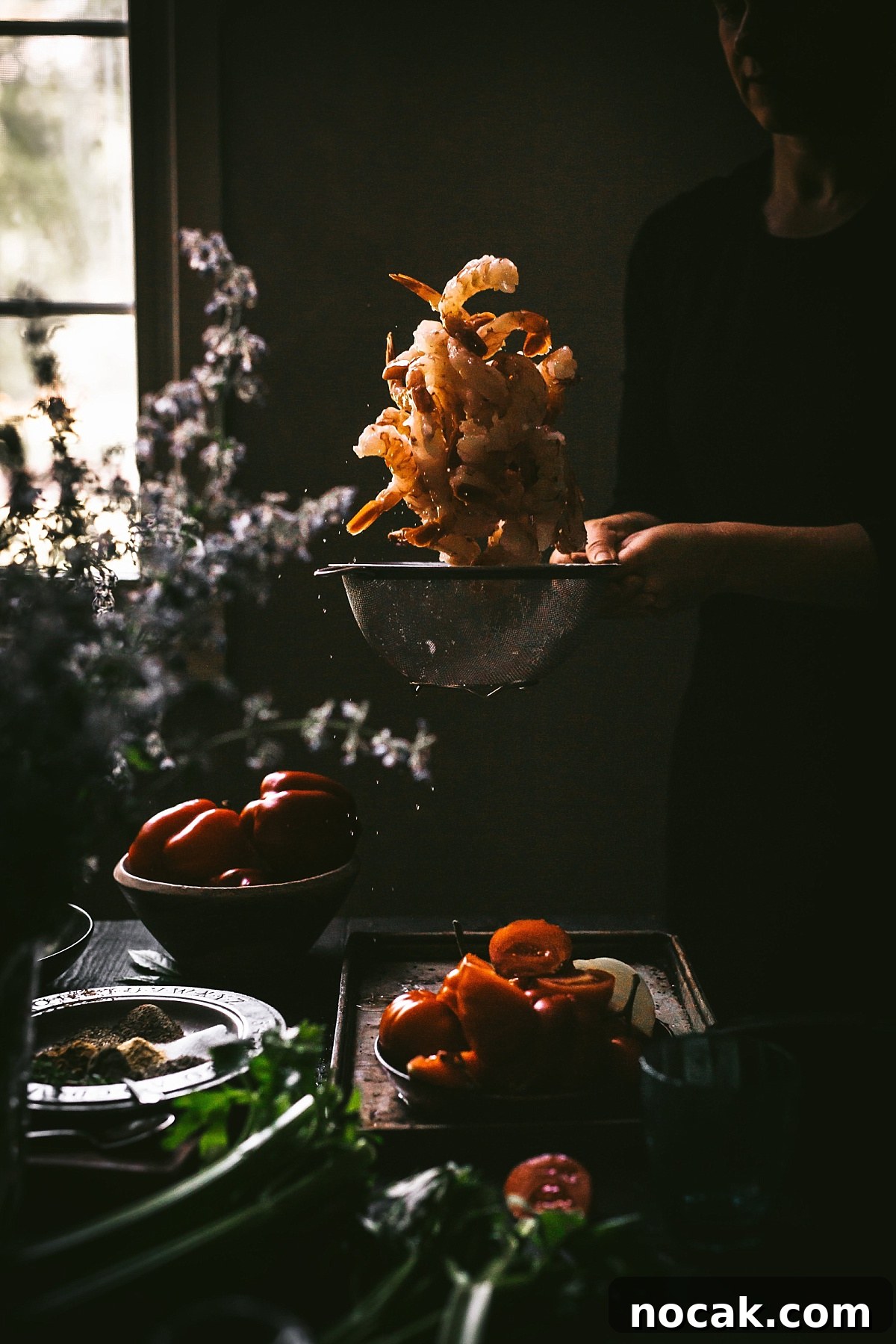 Paul Prudhomme’s Dutch Oven Jambalaya Recipe 4 dramatic action shot of tossing shrimp with cajun seasoning high in air