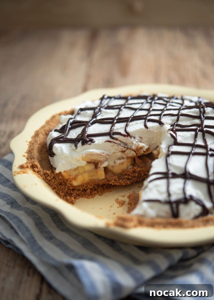 Classic Banoffee Pie Recipe: Creamy Toffee Banana Dessert 3 A piece of slice is taken out from the whole banoffee pie.