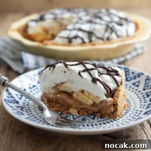 Classic Banoffee Pie Recipe: Creamy Toffee Banana Dessert 9 A slice of banoffee pie is served on a blue plate with a fork.