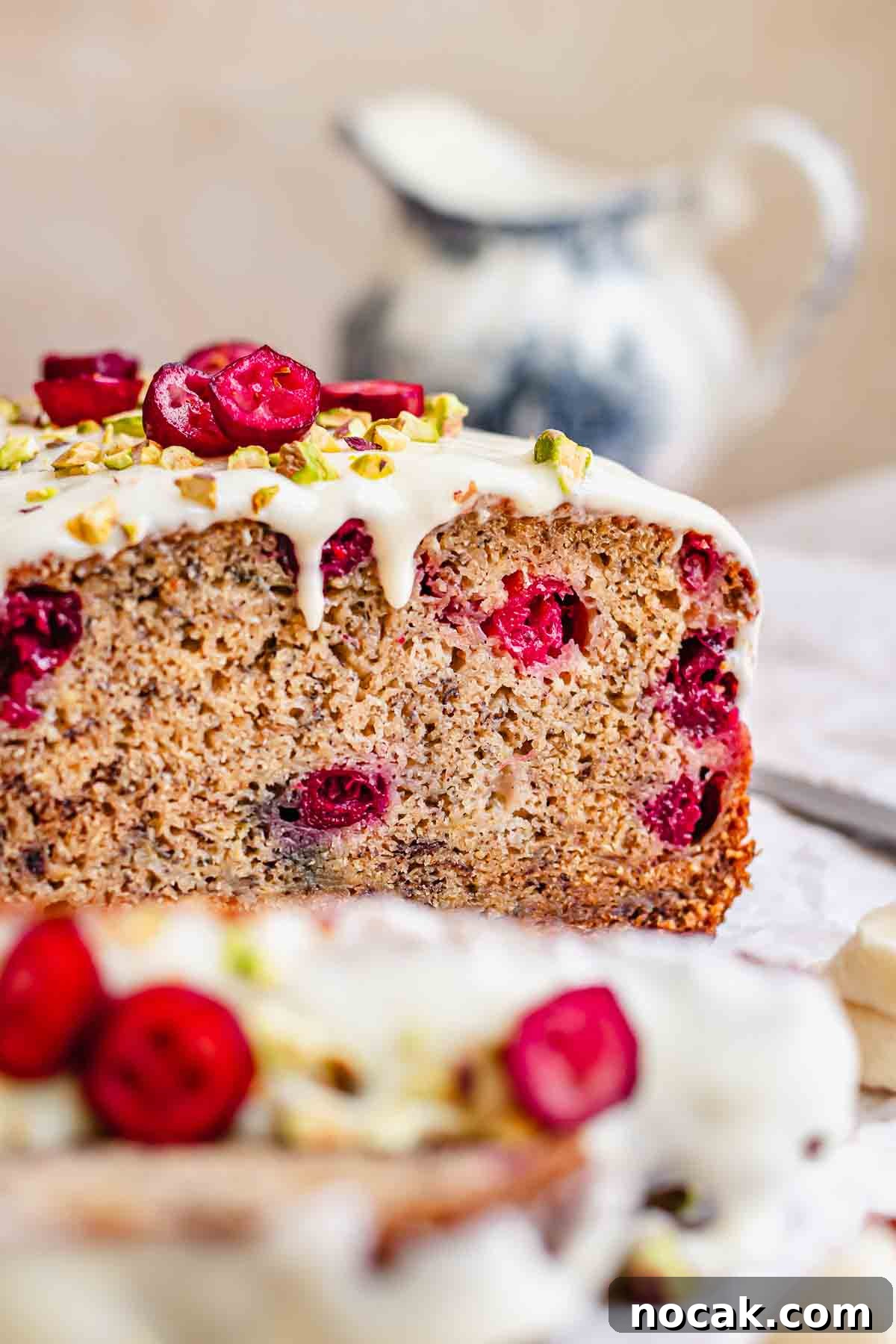 Cranberry Banana Bread Recipe with Zesty Orange Glaze 2 Cranberry banana bread sliced on a. cutting board.