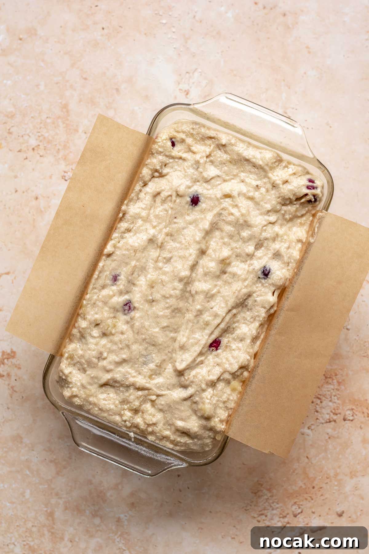 Cranberry Banana Bread Recipe with Zesty Orange Glaze 13 Banana cranberry bread in a loaf pan before baking.