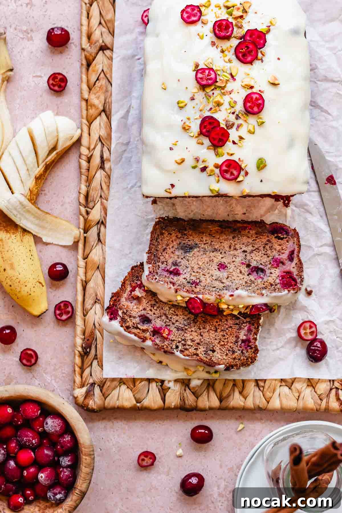Cranberry Banana Bread Recipe with Zesty Orange Glaze 14 Sliced cranberry banana bread with glaze and pistachios.