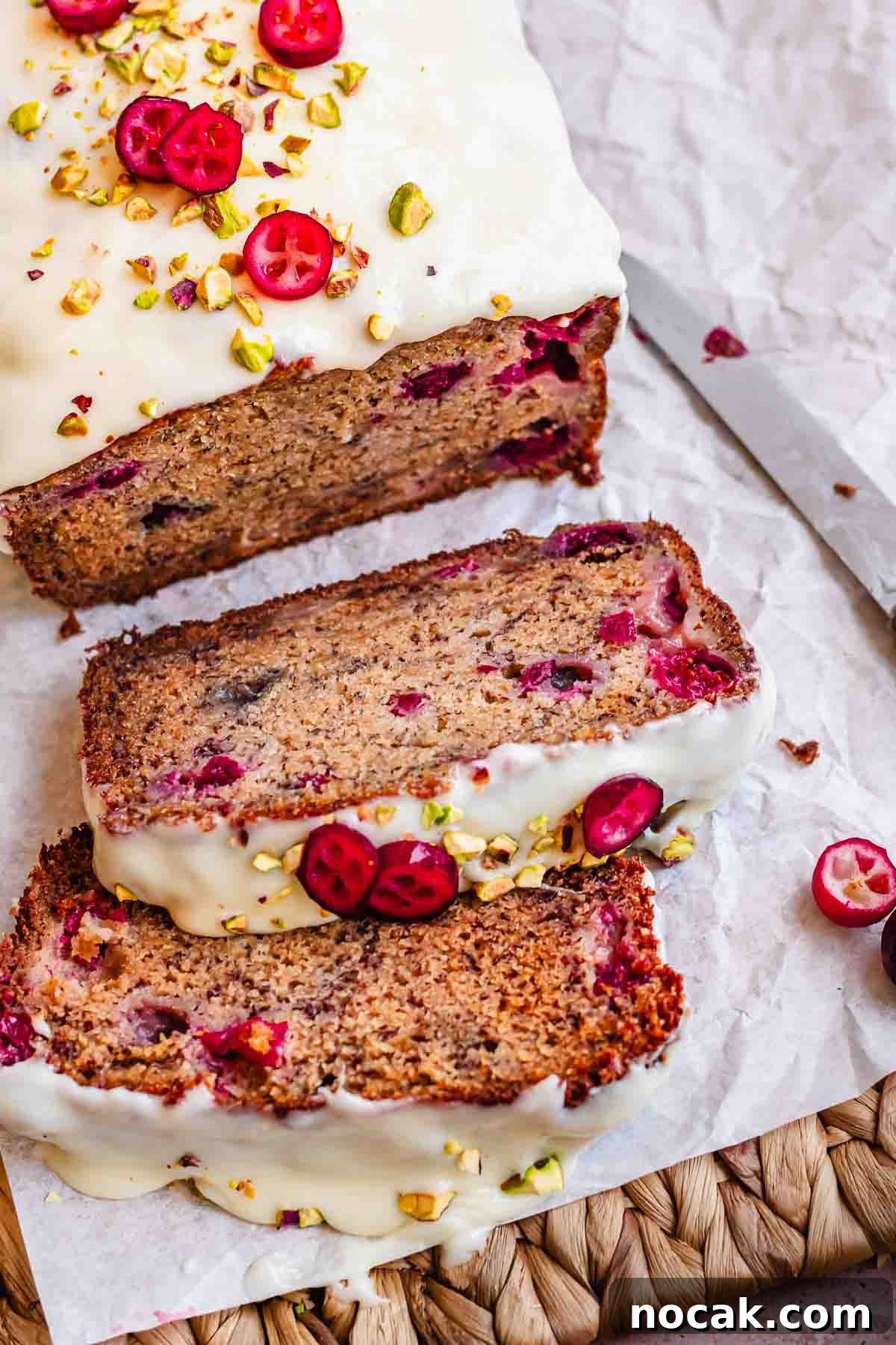 Cranberry Banana Bread Recipe with Zesty Orange Glaze 15 Cranberry banana bread sliced on a. cutting board.