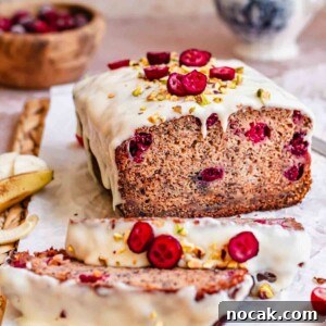 Cranberry Banana Bread Recipe with Zesty Orange Glaze 20 Cranberry banana bread sliced on a. cutting board.