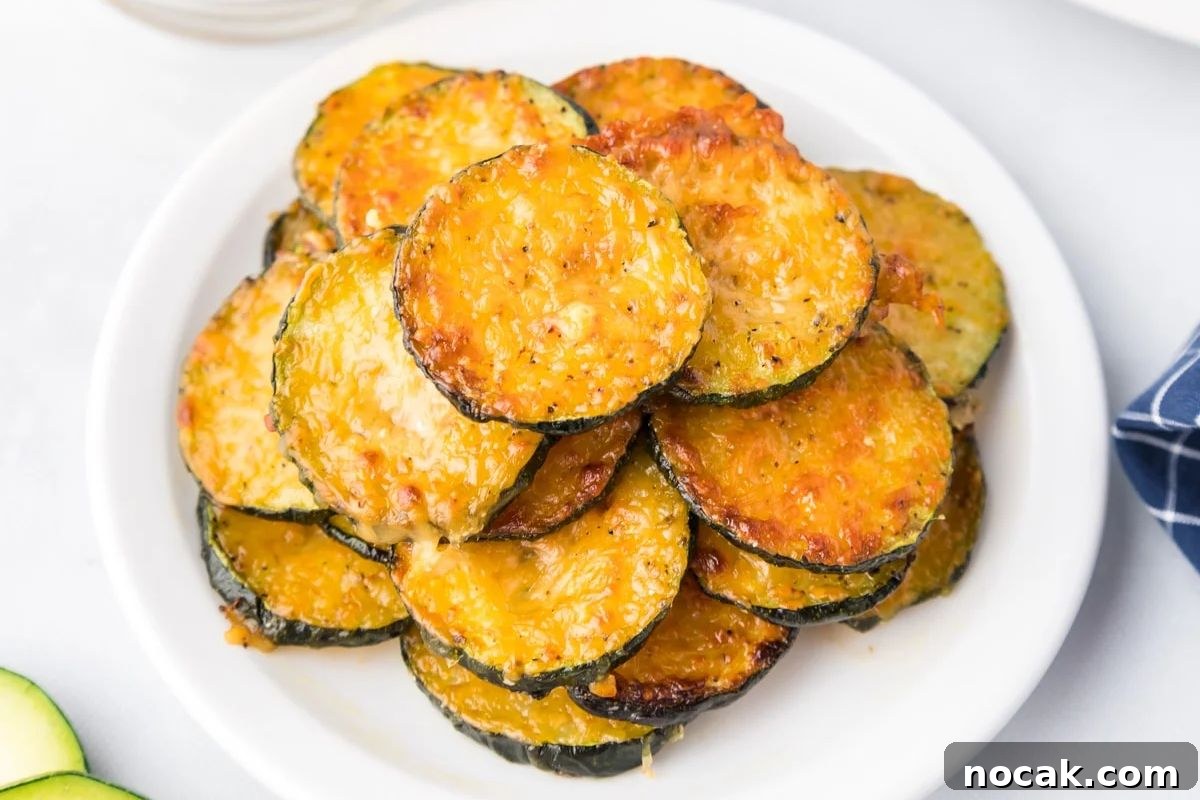 35 Easter Appetizers to Kick Off Your Holiday Feast 18 An Easter appetizer of a stack of baked parmesan-topped zucchini slices on a white plate.