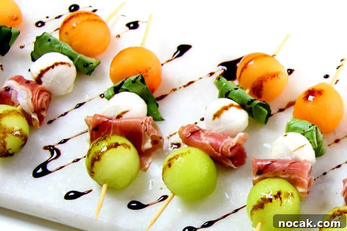 35 Easter Appetizers to Kick Off Your Holiday Feast 21 An arrangement of melon and prosciutto appetizers with balsamic glaze on a white plate, perfect for an Easter appetizer.