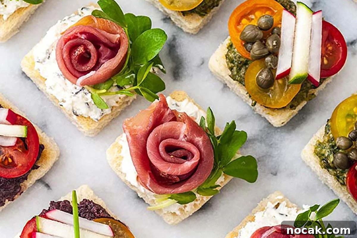 35 Easter Appetizers to Kick Off Your Holiday Feast 28 An assortment of elegant Easter appetizers with various toppings on square crackers arranged on a marble surface.