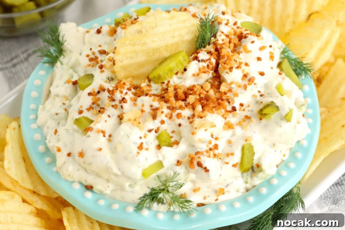 35 Easter Appetizers to Kick Off Your Holiday Feast 34 An Easter appetizer: A plate of potato chips served with a creamy dill pickle dip garnished with pickle pieces, dill, and red spices.