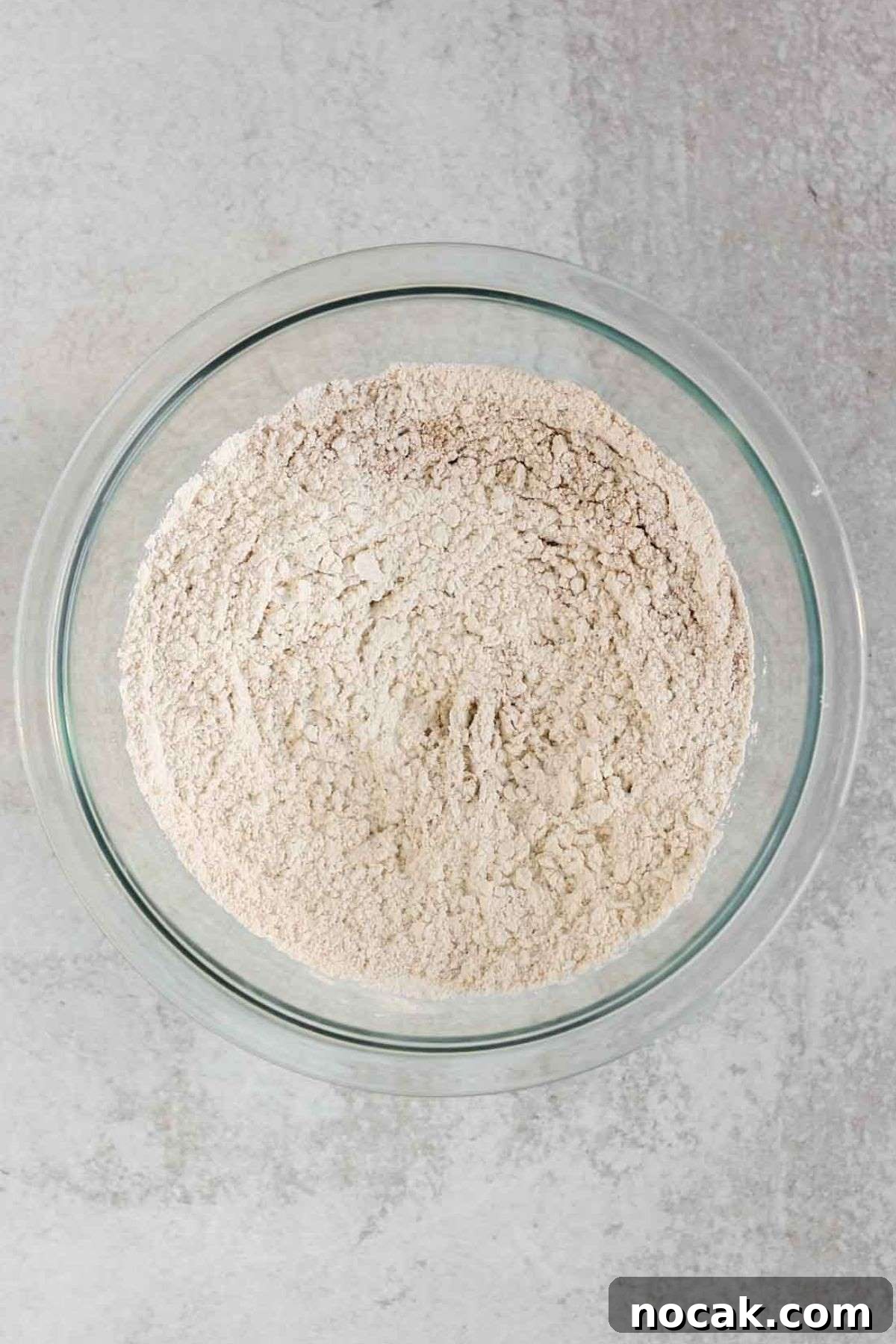 Flour mixture in a small glass mixing bowl.