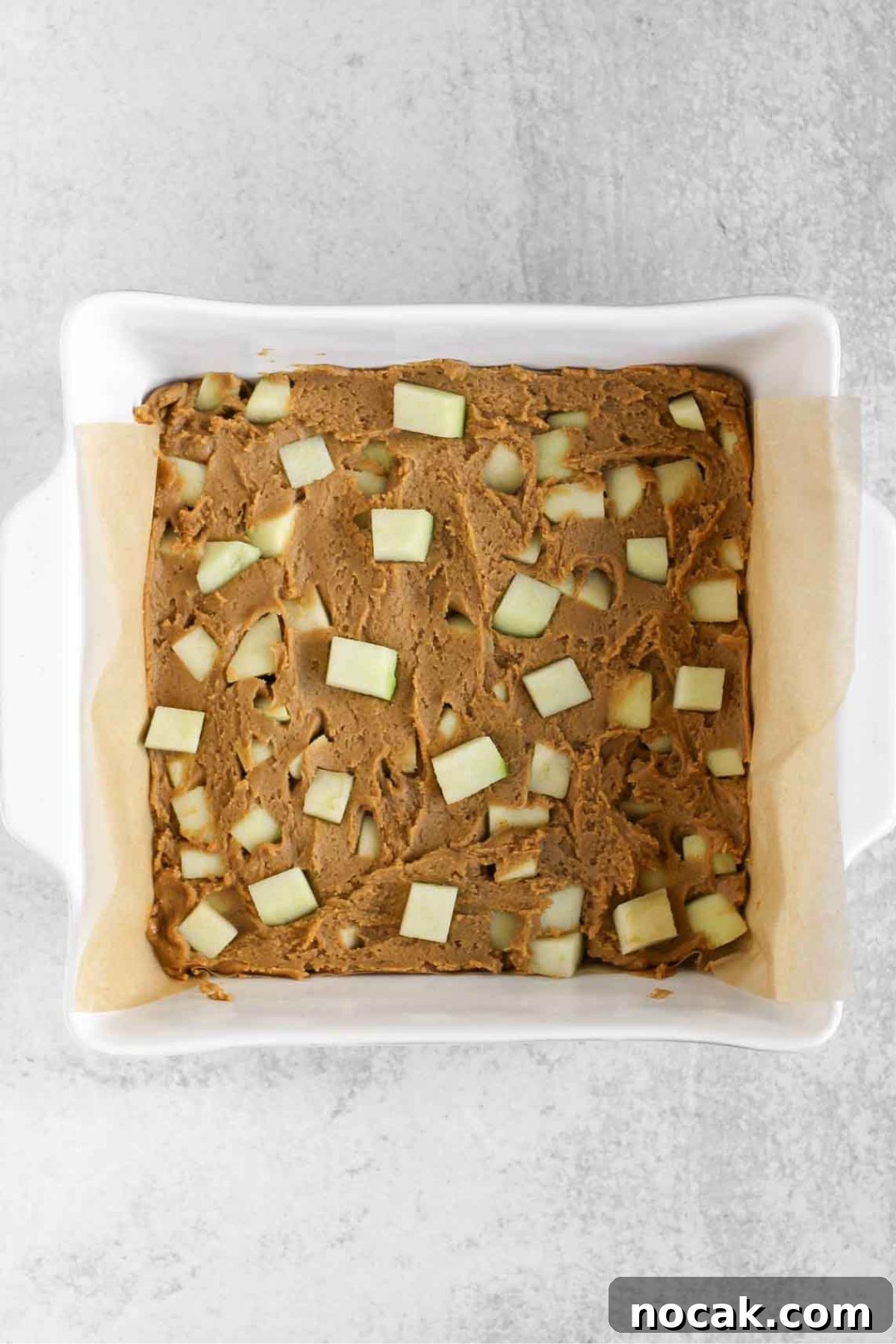 Apple blondie better in a square baking dish lined with parchment paper.