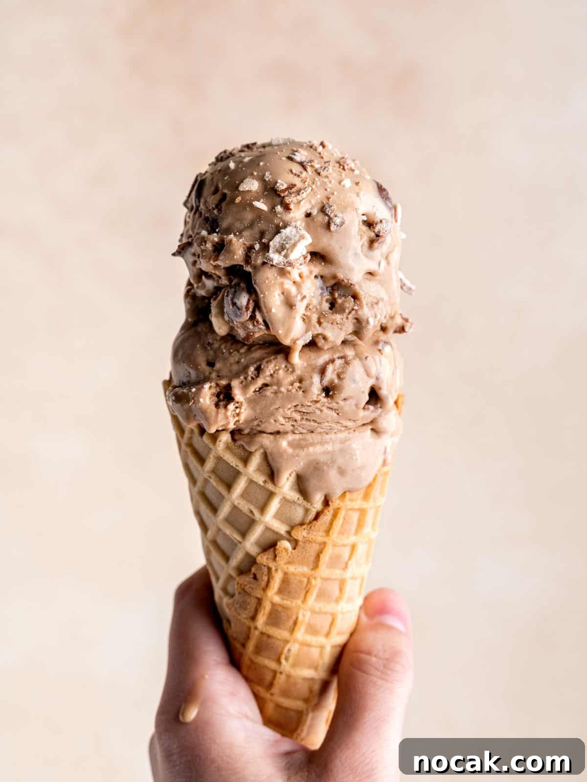 Chocolate Malted Crunch Ice Cream Recipe: Creamy Malted Chocolate with Crispy Crunch 2 Scoops of homemade chocolate malted crunch ice cream in a waffle cone.