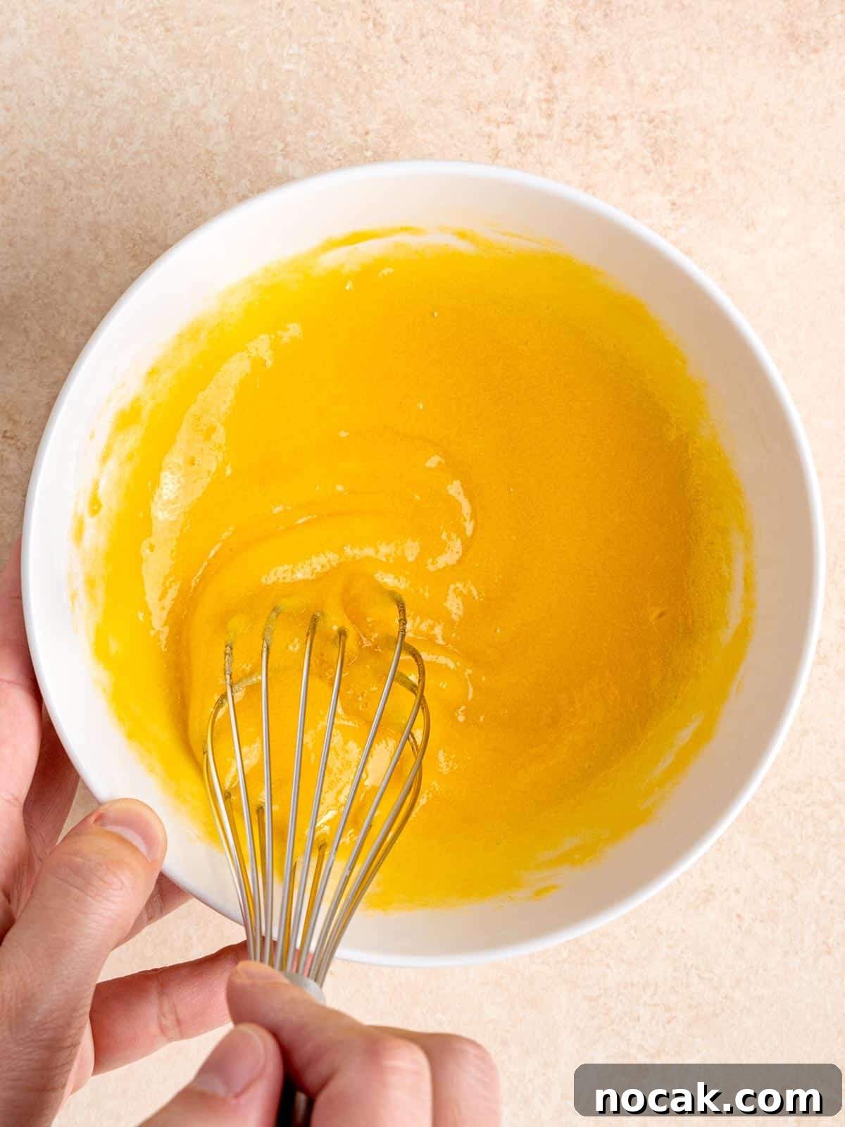 Chocolate Malted Crunch Ice Cream Recipe: Creamy Malted Chocolate with Crispy Crunch 4 Whisking egg yolks and sugar in a bowl.