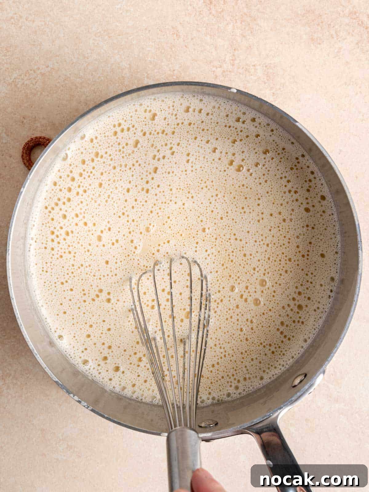 Chocolate Malted Crunch Ice Cream Recipe: Creamy Malted Chocolate with Crispy Crunch 6 Whisking ice cream mixture in a pot.
