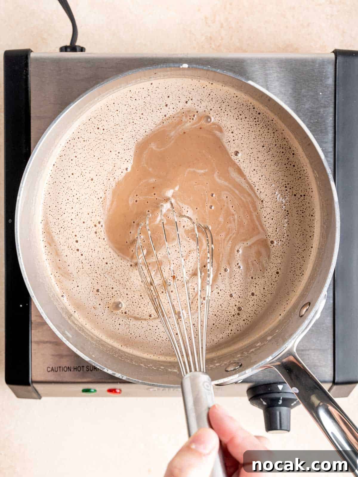 Chocolate Malted Crunch Ice Cream Recipe: Creamy Malted Chocolate with Crispy Crunch 8 Whisking chocolate malt ice cream mixture in a pot.