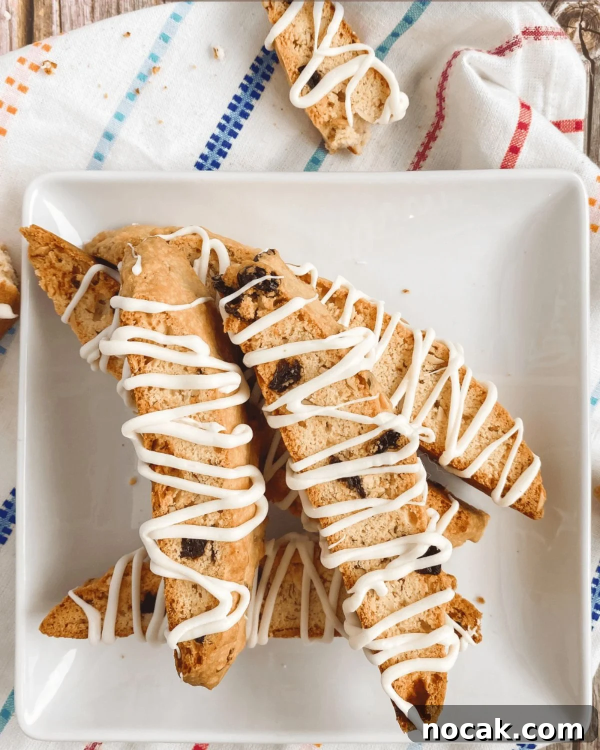 cherry almond biscotti on a square plate.