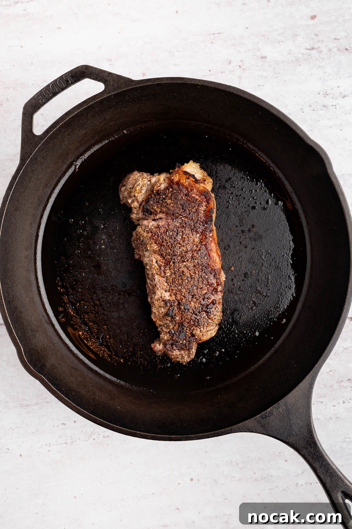 Steak Salad with Avocado-Lime Cilantro Crema Recipe 5 The seared steak in a cast iron skillet.