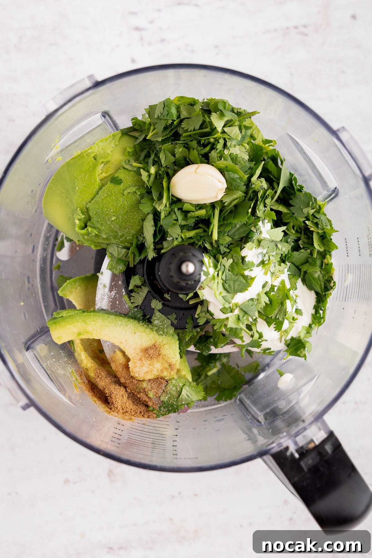 Steak Salad with Avocado-Lime Cilantro Crema Recipe 7 All of the ingredients for the avocado-lime crema in the food processor bowl before blending.