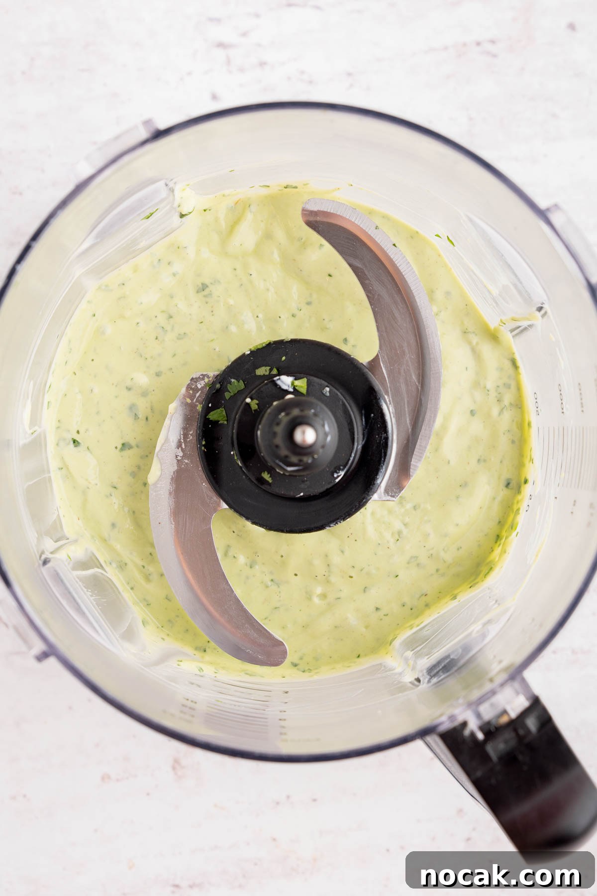 Steak Salad with Avocado-Lime Cilantro Crema Recipe 8 The avocado-lime cilantro crema in the food processor bowl after blending.