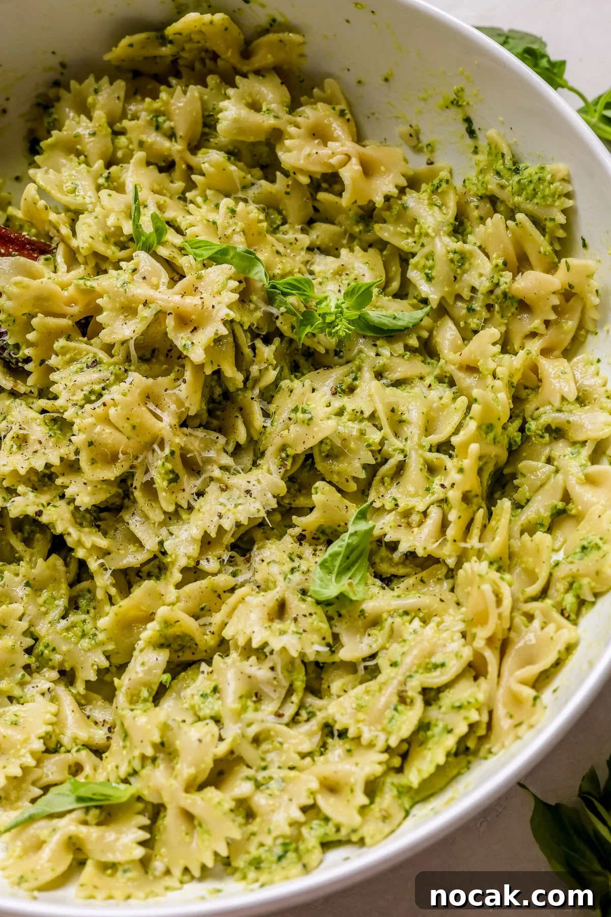 Creamy Avocado Pesto Pasta Recipe for Quick Weeknight Meals 2 pesto pasta in a large white bowl.