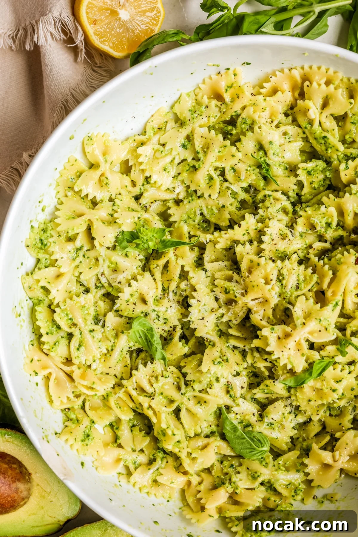 Creamy Avocado Pesto Pasta Recipe for Quick Weeknight Meals 7 pesto pasta in a large white bowl.