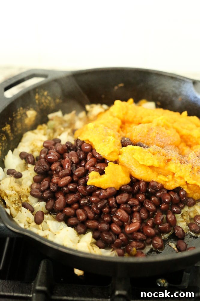 Preparing the mixture for ButternutSquash Black Bean Enchiladas recipe--ingredients in pan