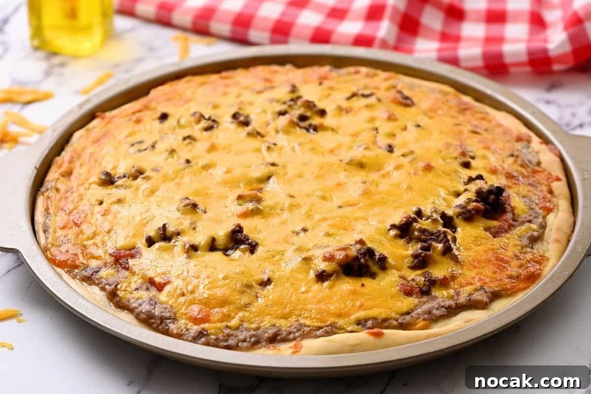 Easy Taco Pizza Recipe Baked taco pizza on pizza pan.