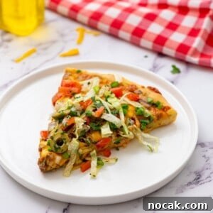 Taco Pizza Recipe: How to Make Crispy, Flavorful Taco Pizza 2 Slice of taco pizza with toppings on white plate.