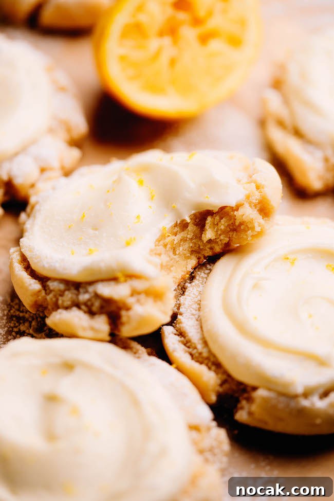 Soft Chewy Lemon Sugar Cookies Recipe for Perfect Texture 3 Bite shot of lemon sugar cookie with cream cheese frosting.