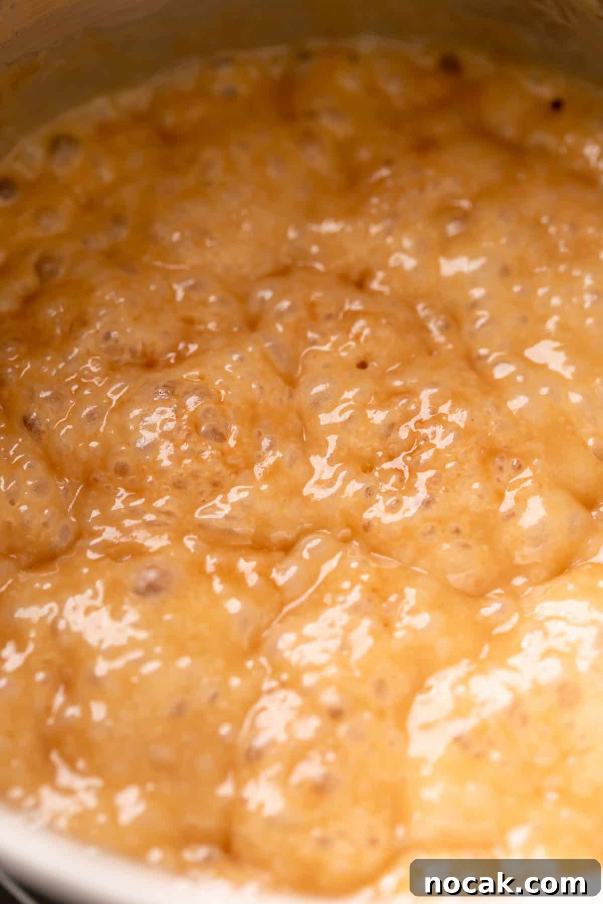 Salted Caramel Pecan Bars Recipe — Chewy Pecan Caramel Squares 8 golden brown caramel bubbling in a pot.