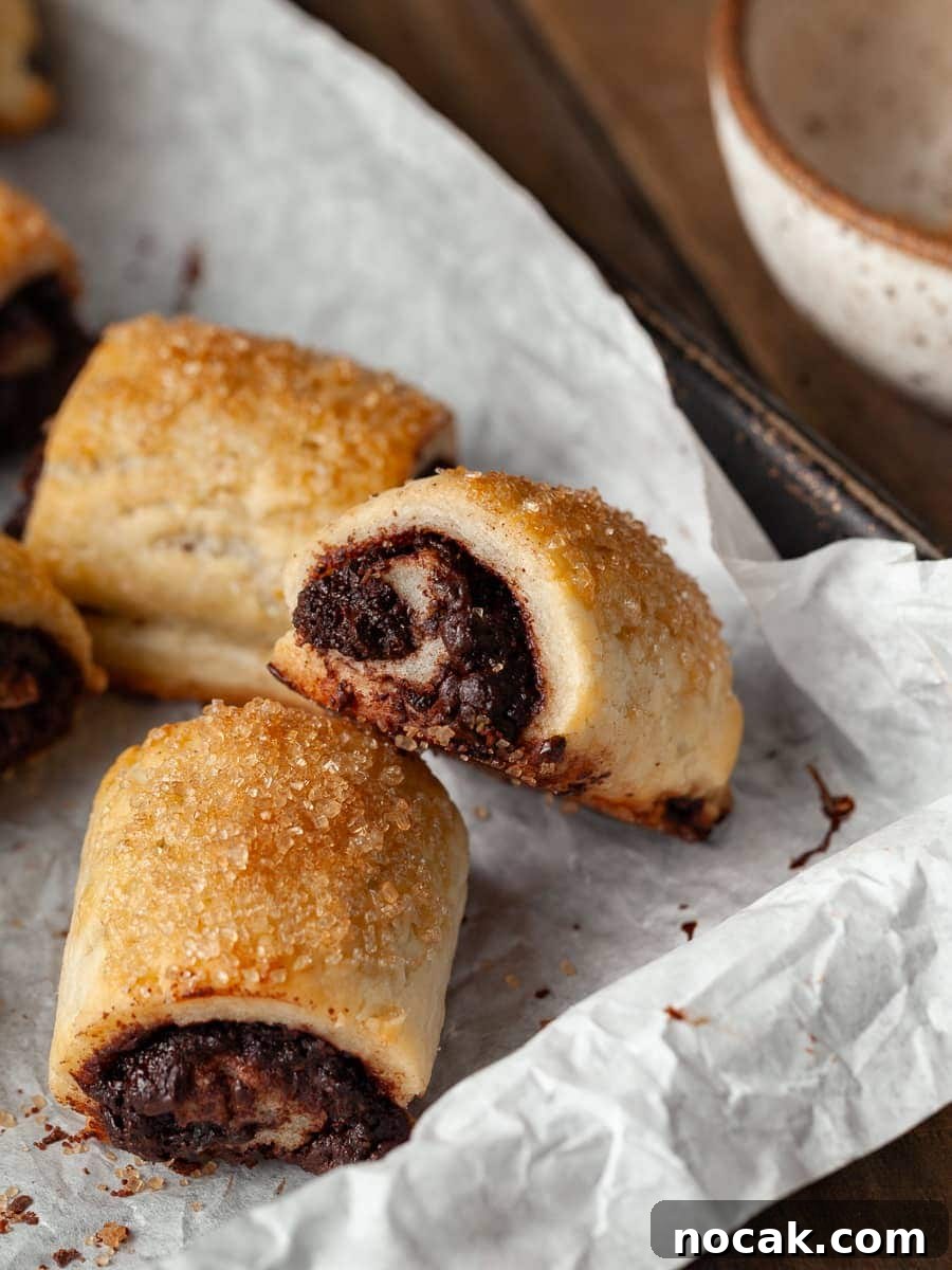 Gluten Free Rugelach with Chocolate Filling on White parchment paper on a sheet tray